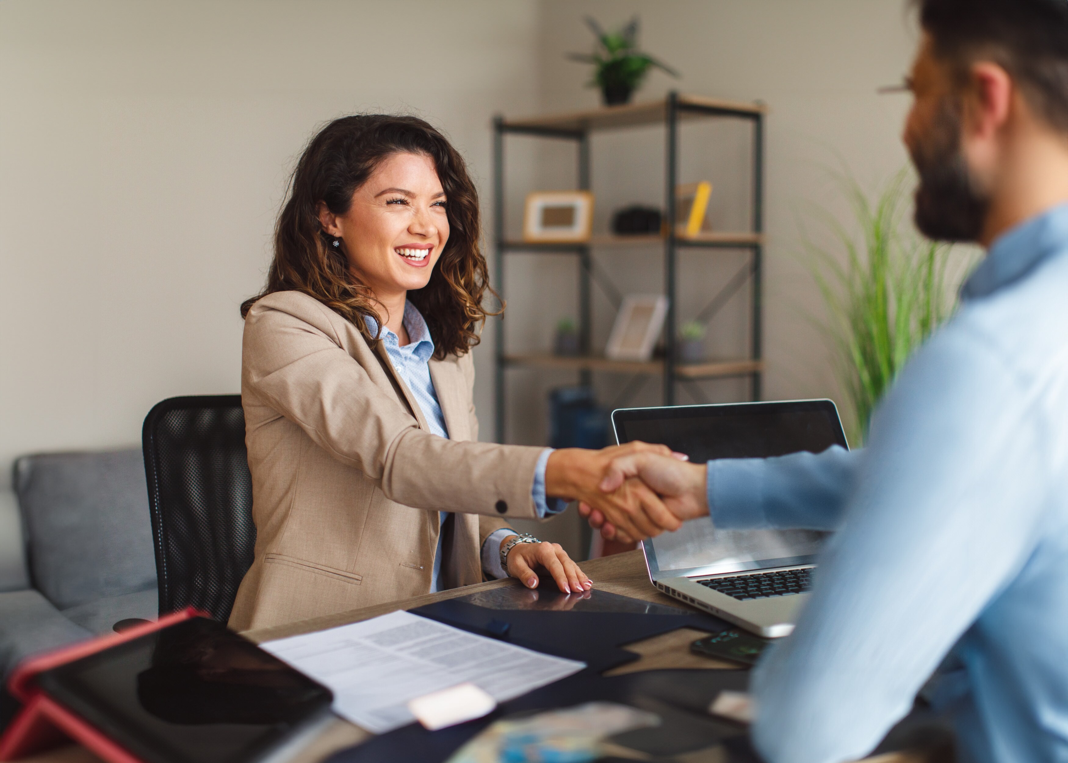 Illustration of a woman shaking a man's hand with a happy expression