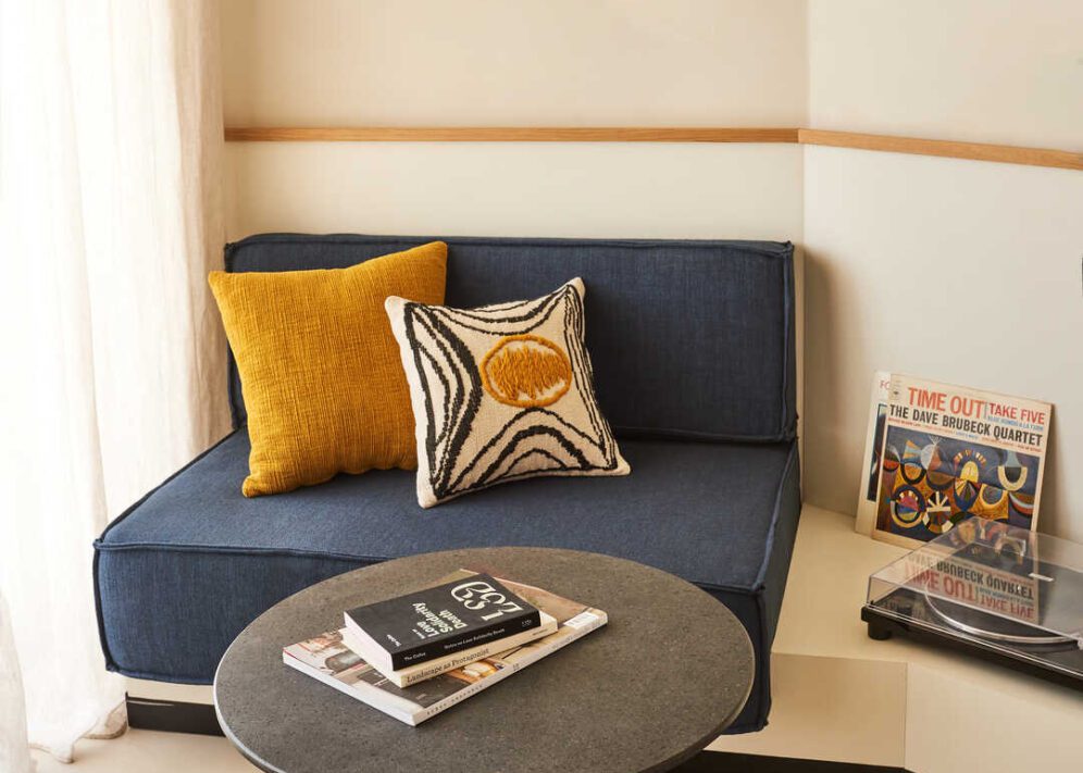 A stone table provides reading material local to the city and a blue chair provides a place to study it