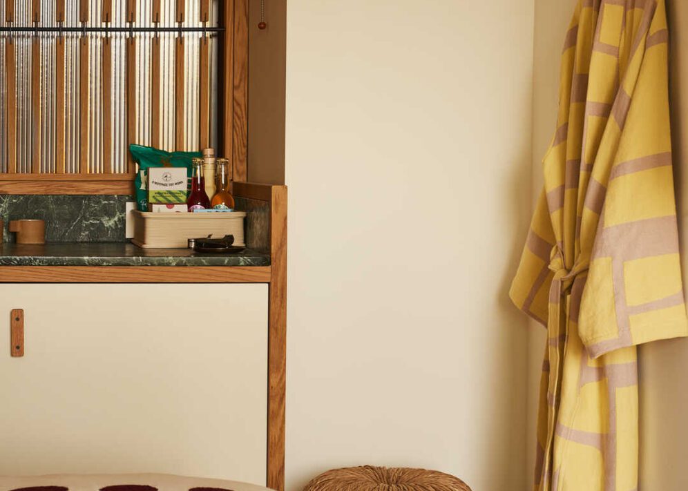 A green limestone counter provides a space for a curated selection of minibar libations and snacks