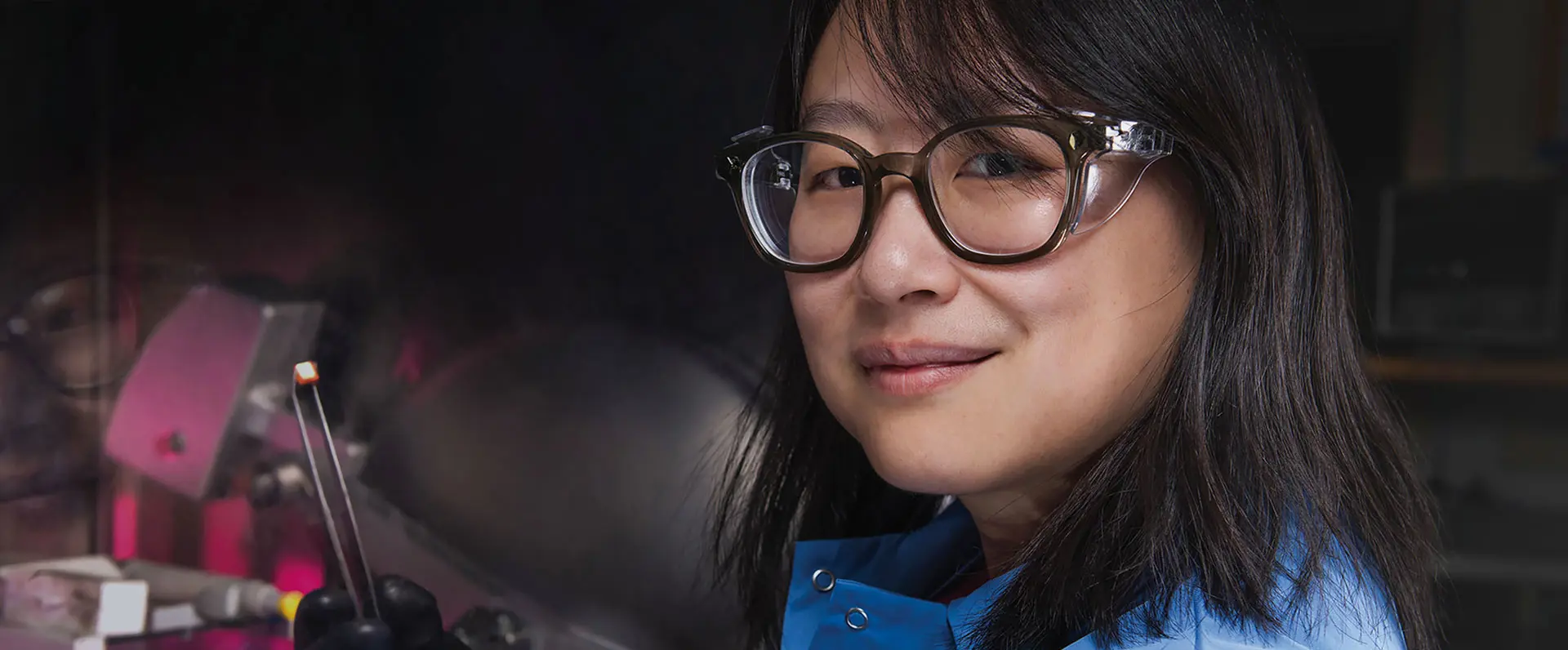 Smiling employee at LANL wearing protective glasses