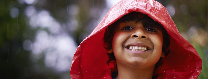 Shot of an enthusiastic little boy wearing a raincoat outside