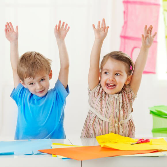 Children with Hands in the Air