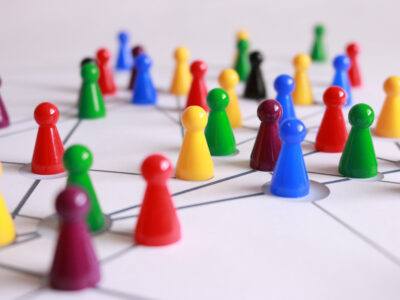 board game pieces spread out over networking lines