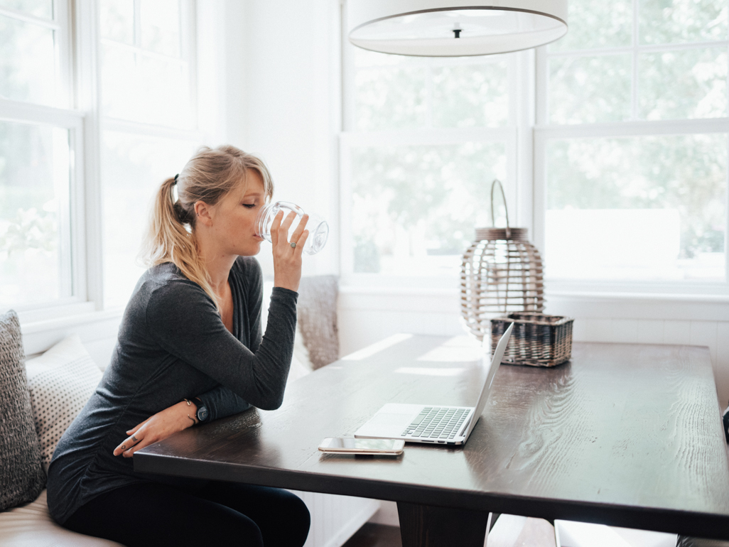 pregnant woman drinking a glass of water