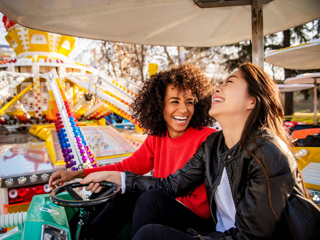 women having fun in a park ride