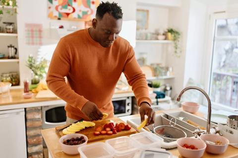 Person prepping different foods in kitchen