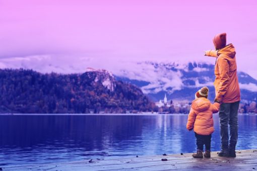 Father and Son Standing Near A Lake