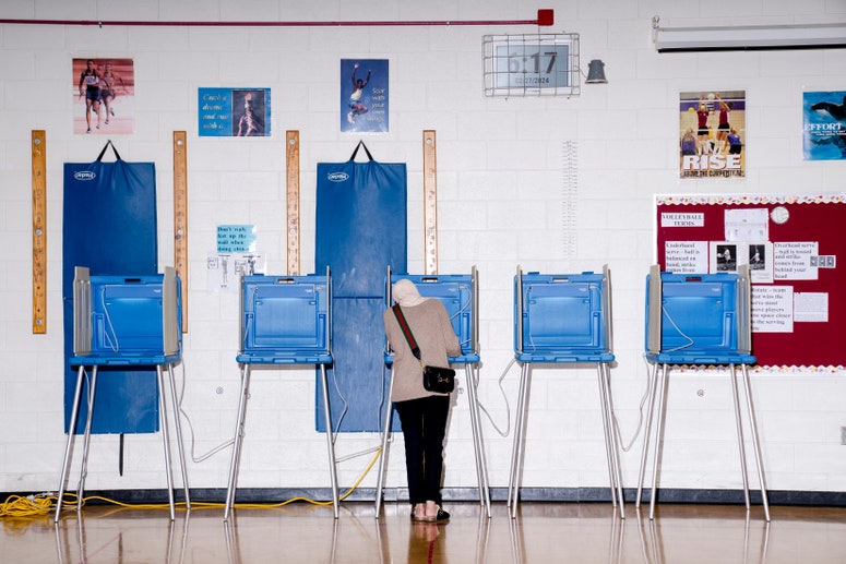 A voter casts their ballot at a polling station at William Ford Elementary School in Dearborn, Michigan, US, on Tuesday, Feb. 27, 2024