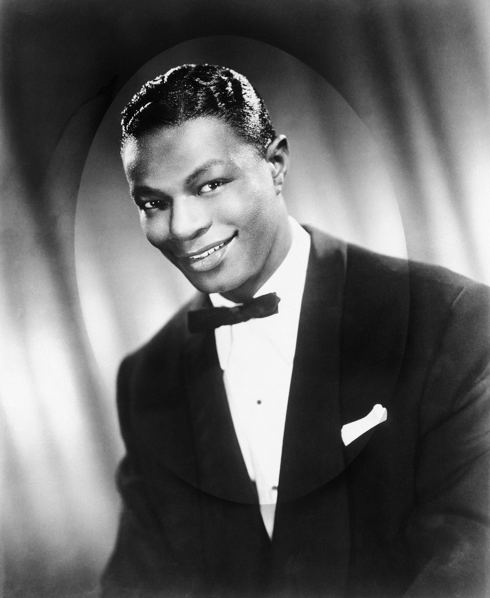 Image may contain Nat King Cole Face Head Person Photography Portrait Clothing Formal Wear Suit Happy and Smile