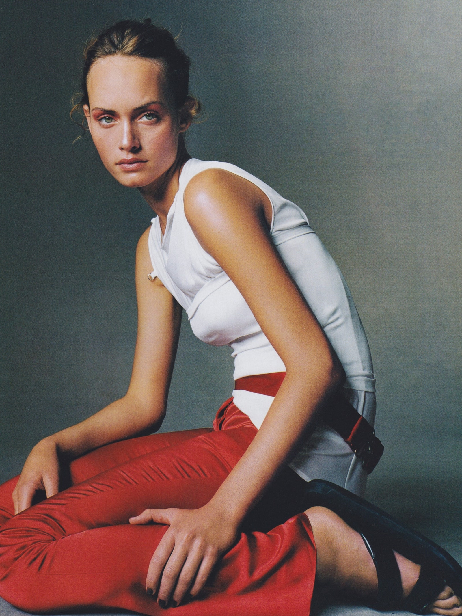 Image may contain Amber Valletta Adult Person Face Head Photography Portrait Clothing Glove and Sitting