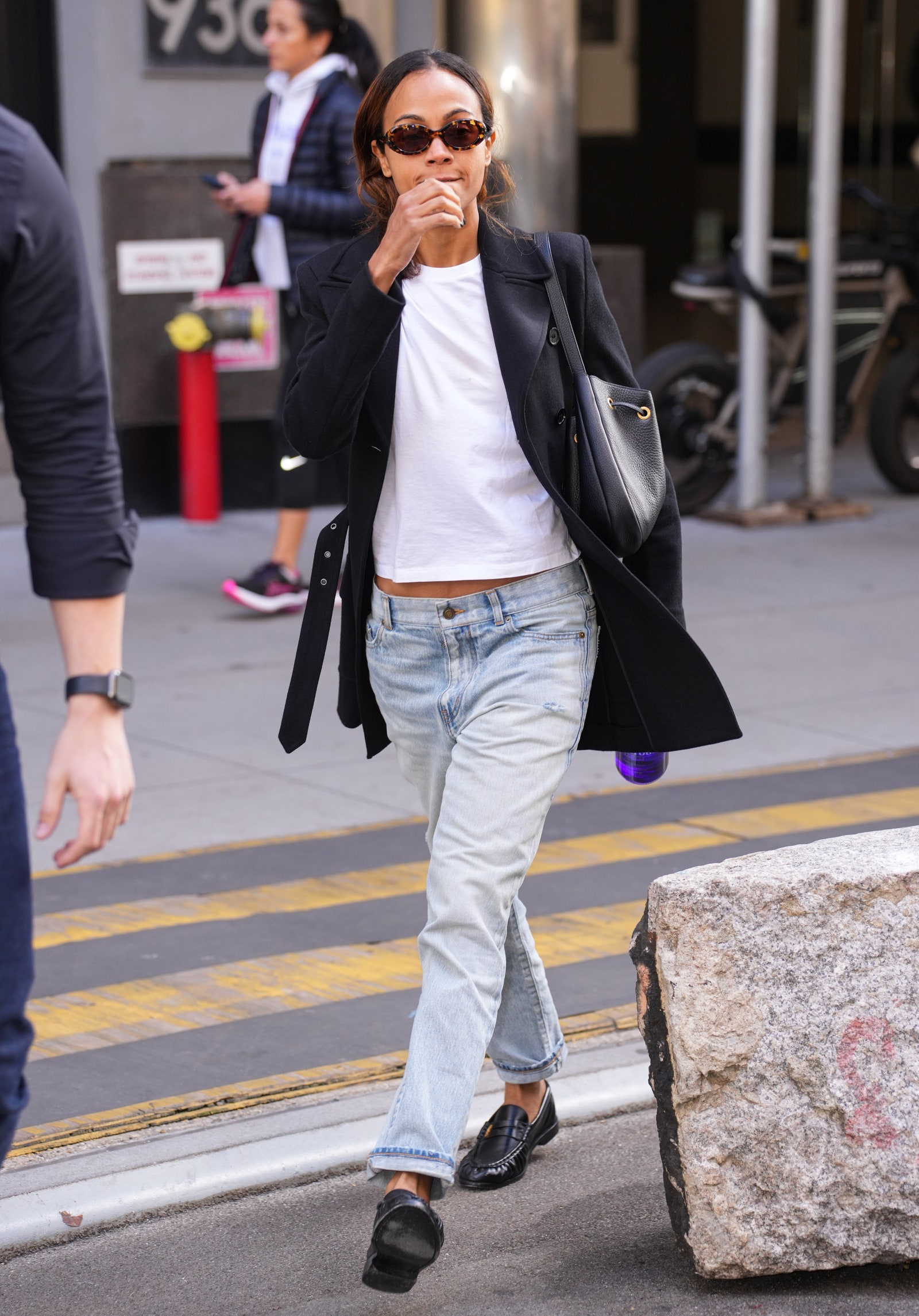 Image may contain Zoe Saldana Emma Snowsill Clothing Pants Pedestrian Person Jeans Footwear Shoe and Wristwatch