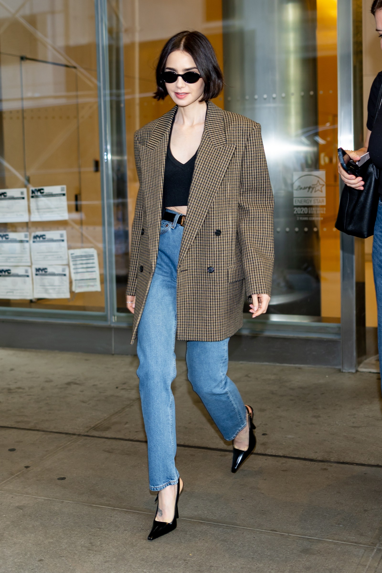 Image may contain Lily Collins Clothing Coat Pants Blazer Jacket Footwear High Heel Shoe Accessories and Glasses