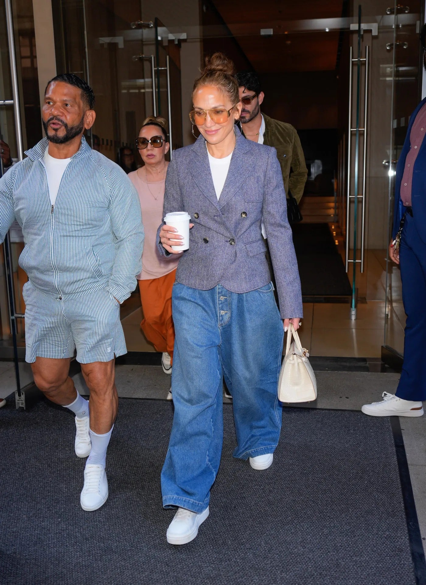 Image may contain Benny Medina Jennifer Lopez Pat Cleveland Clothing Pants Accessories Bag Handbag and Jeans