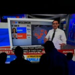 People watch results come in on a television screen at the DFL election night party, Tuesday, Nov. 5, 2024, in St. Paul, Minn.