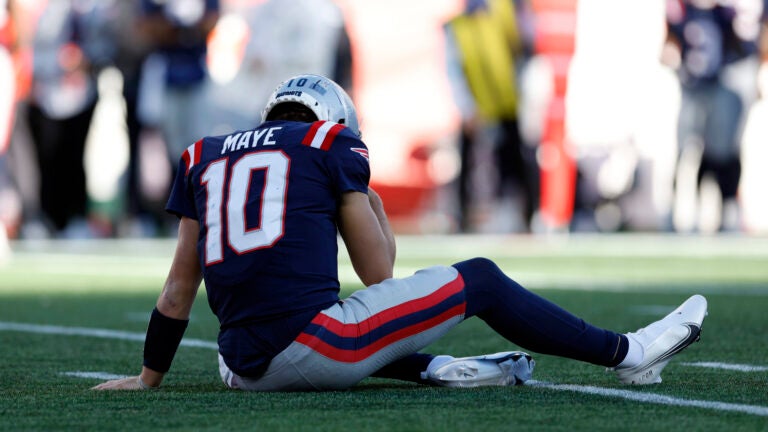 New England Patriots quarterback Drake Maye (10) lays on the ground after fumbling the ball during the first quarter at Gillette Stadium.