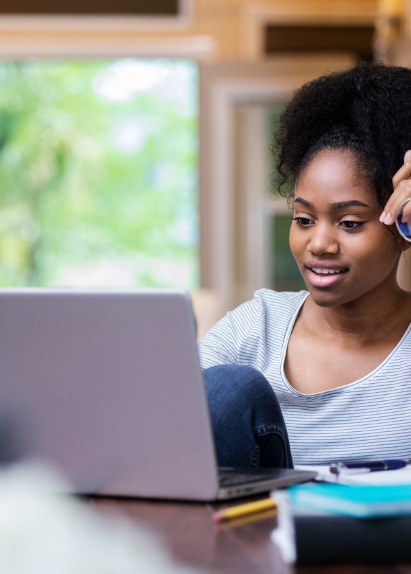 Woman holding glasses on computer