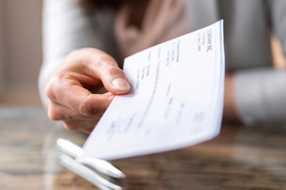 Woman handing over check