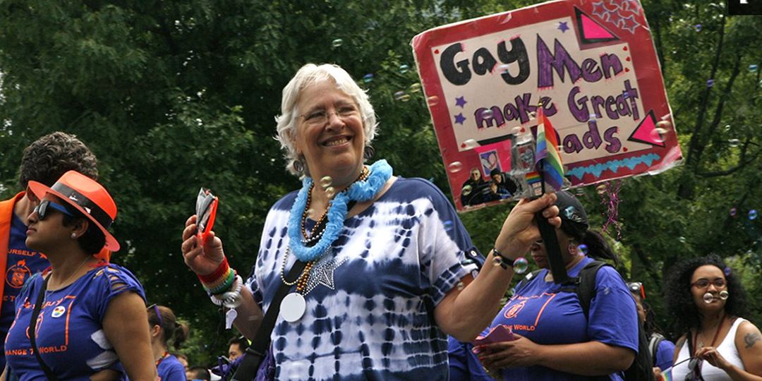 A parade participant showed off a sign supporting gay fatherhood that reads, "Gay Men Make Great Dads" during the 2014 Boston Pride parade