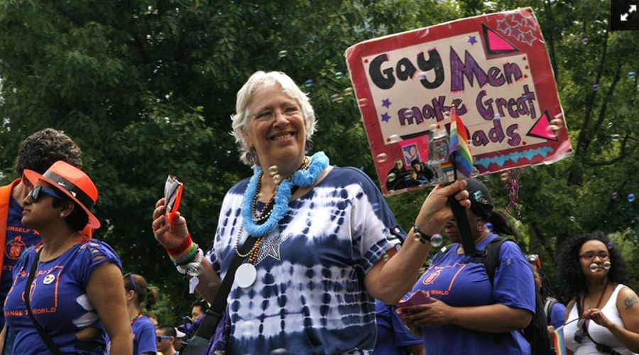 A parade participant showed off a sign supporting gay fatherhood that reads, "Gay Men Make Great Dads" during the 2014 Boston Pride parade