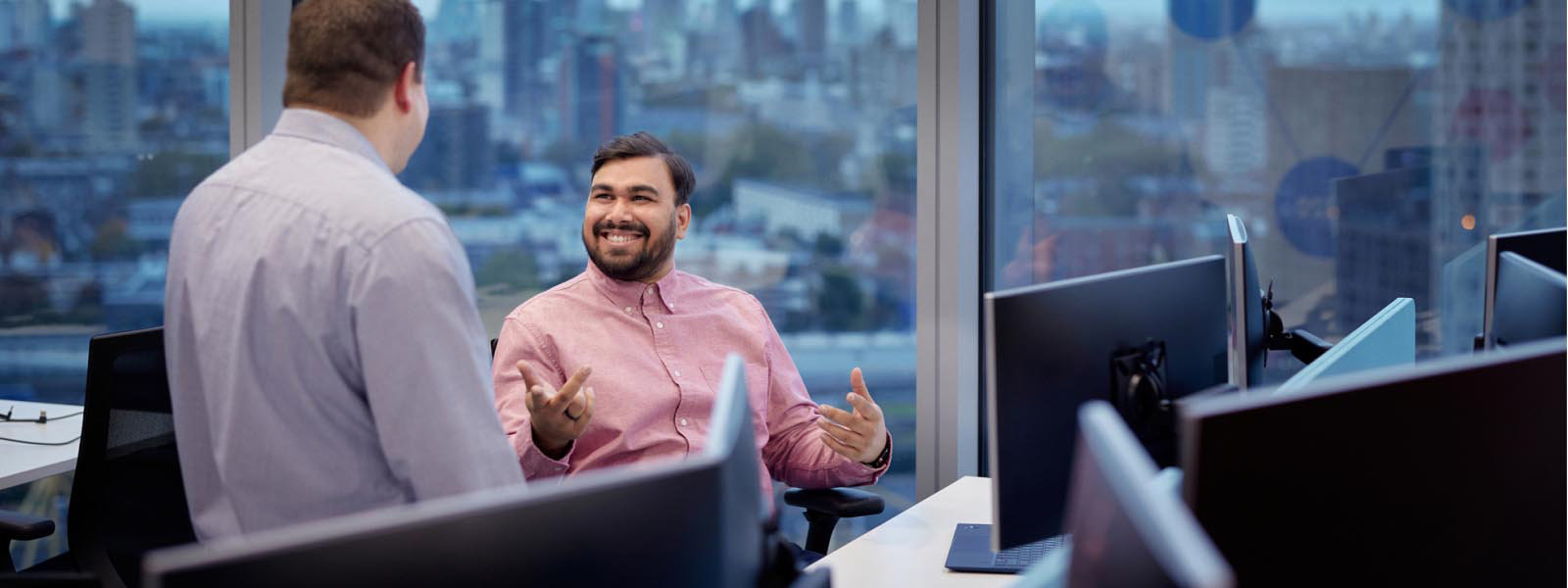 Two coworkers in front of Microsoft devices