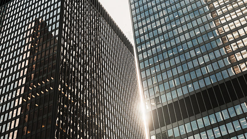 Exterior view of two skyscraper towers in a city setting.