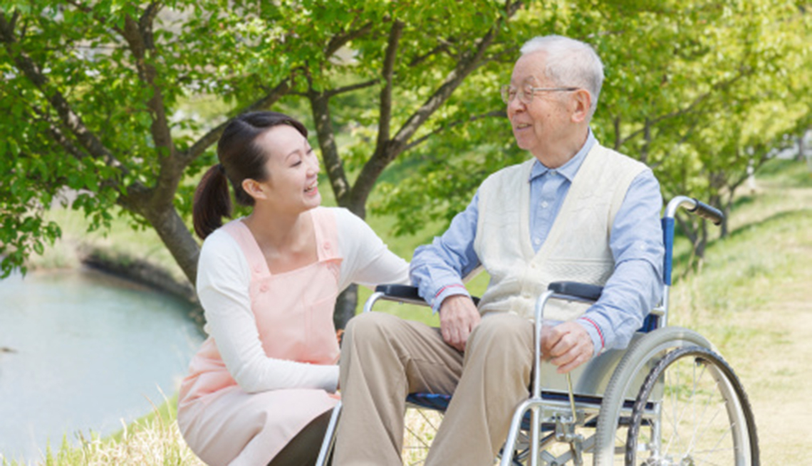 man in wheelchair and his caregiver or friend