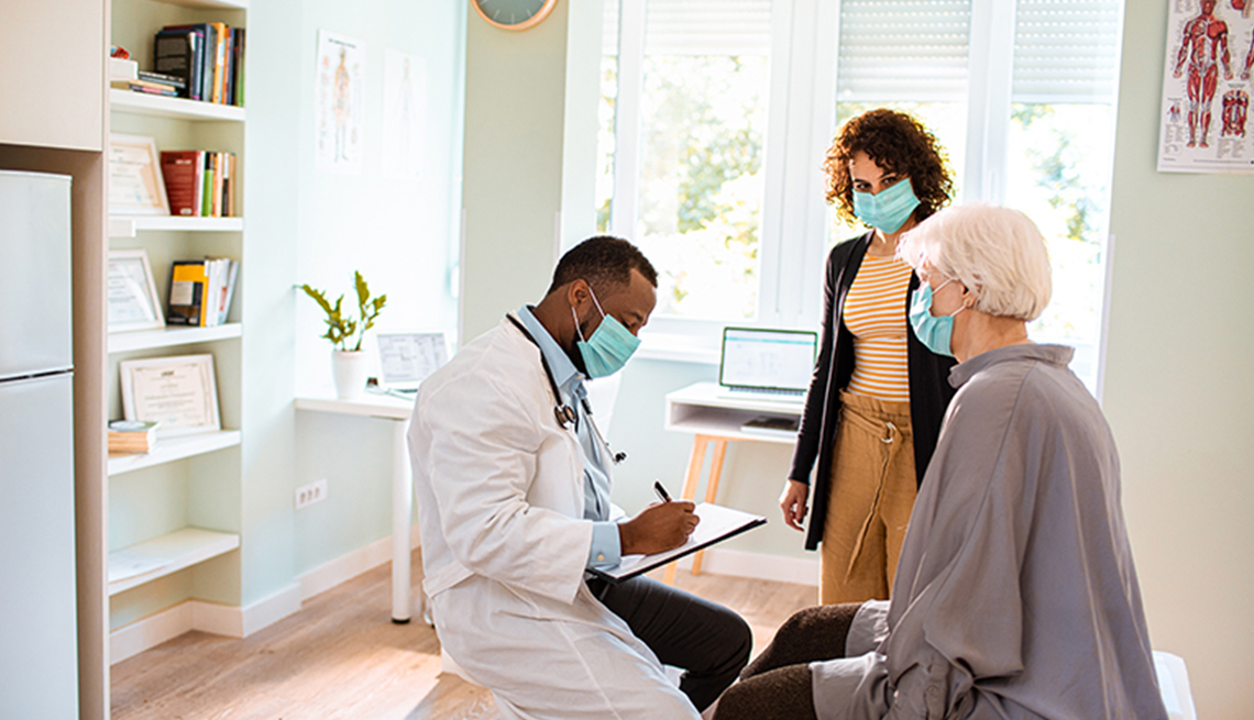 doctor talking to mother and her young daughter