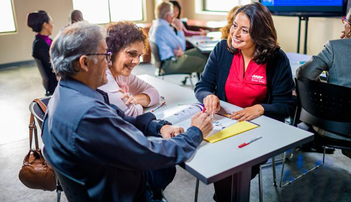 Female A A R P  volunteer talking to a man and a woman