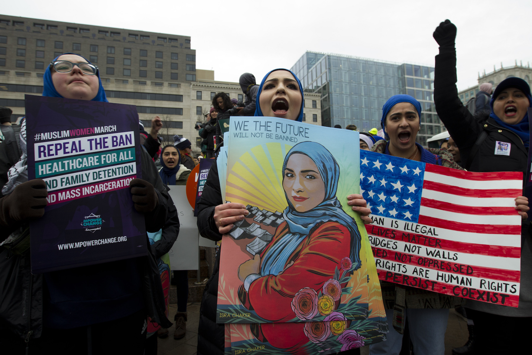 A group holds up signs at Freedom Plaza during the Women's March in Washington on Saturday, Jan. 19, 2019.