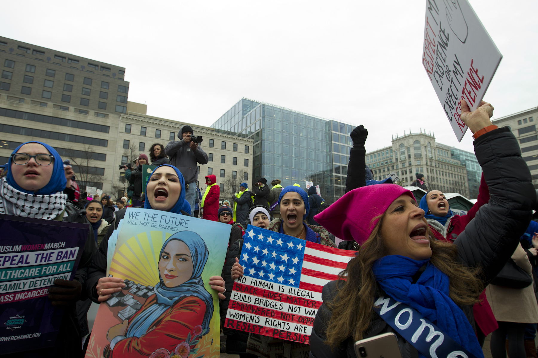 A group holds up signs at Freedom Plaza during the Women's March in Washington on Saturday, Jan. 19, 2019.