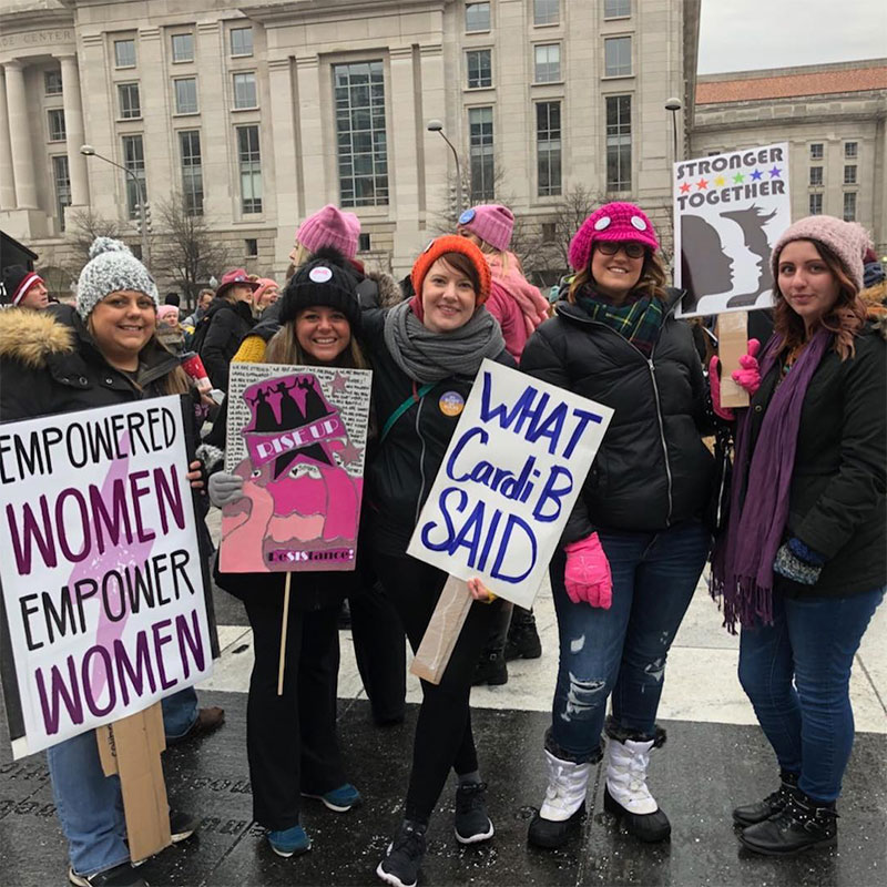 Demonstrators hold up signs during the Women's March in Washington on Saturday, Jan. 19, 2019.