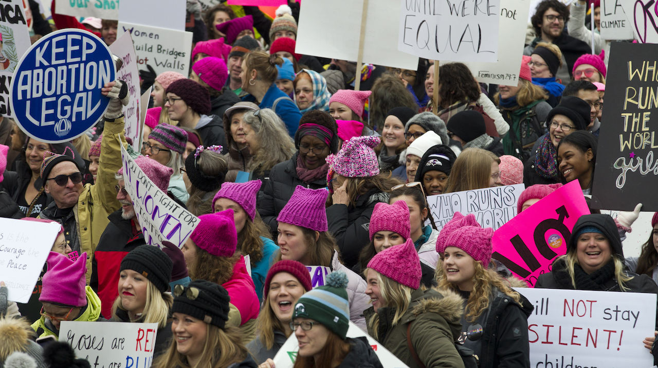 Demonstrators hold up their banners as they march on Pennsylvania Avenue during the Women's March in Washington on Saturday, Jan. 19, 2019.