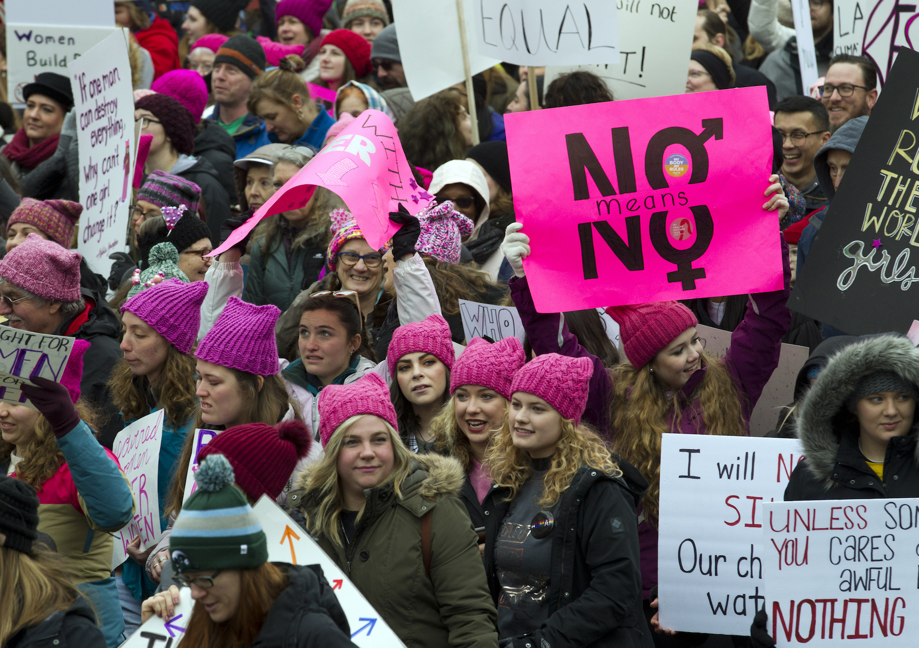 Demonstrators hold banners as they march on Pennsylvania Avenue during the Women's March in Washington on Saturday, Jan. 19, 2019.