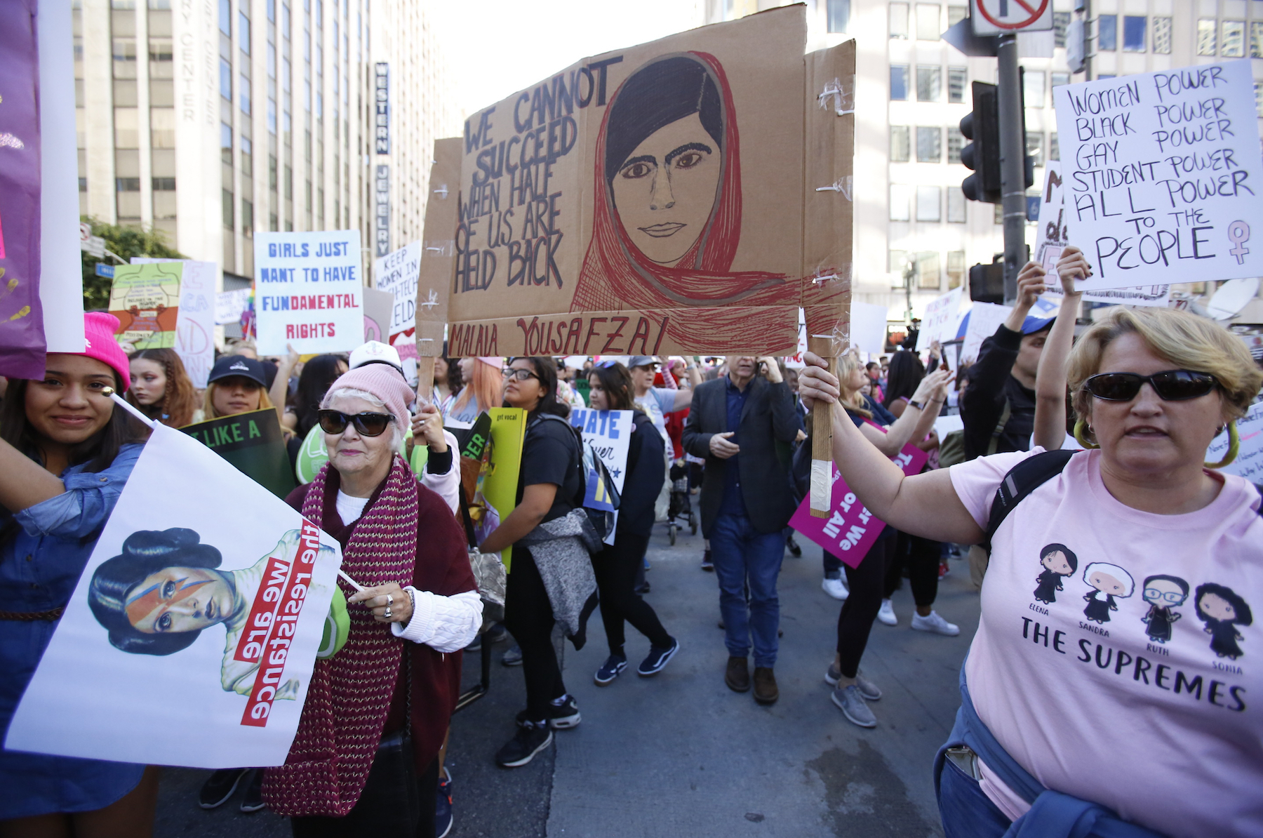 Demonstrators hold signs during the Women's March in Los Angeles on Saturday, Jan. 19, 2019.