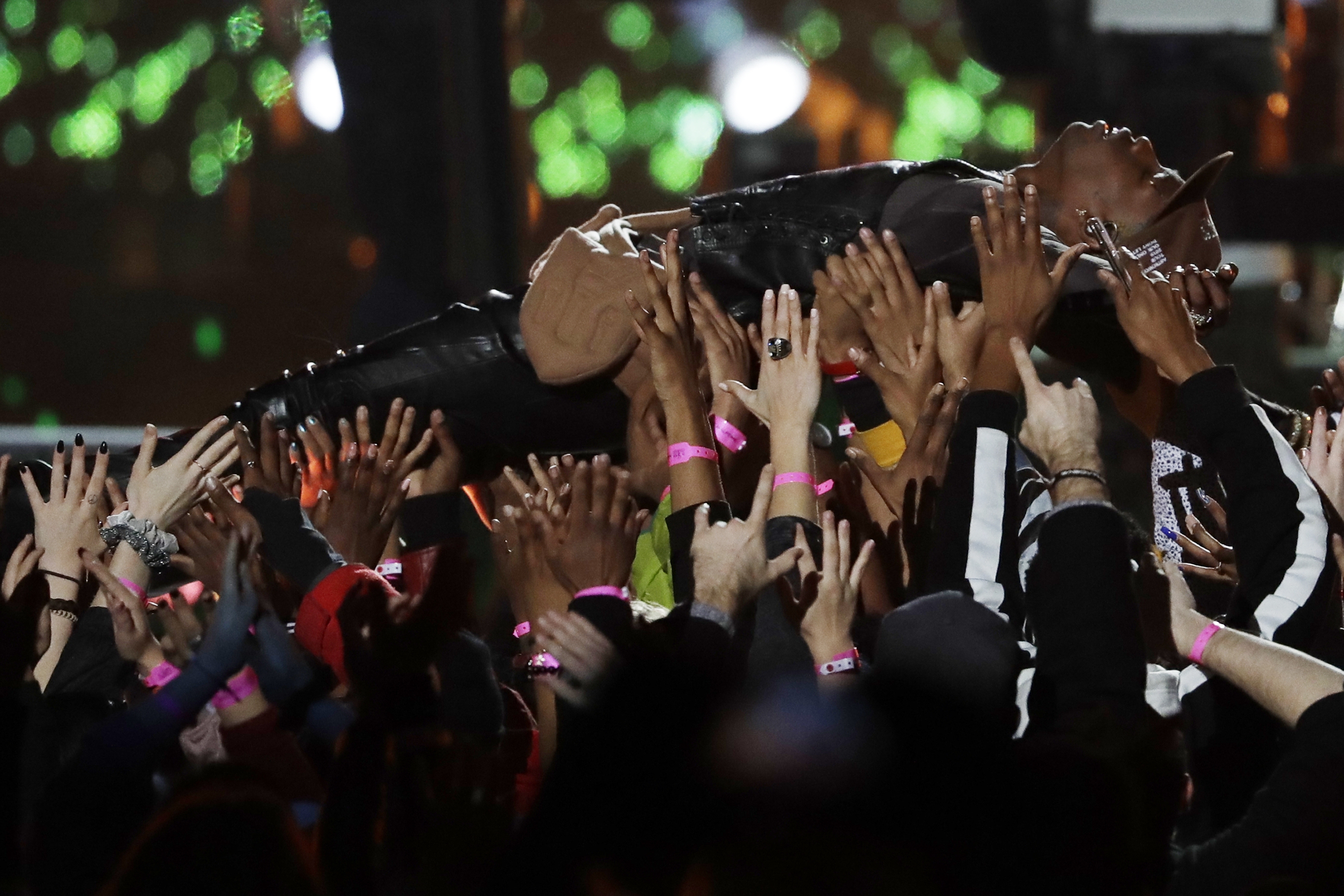 Travis Scott is carried by the crowd during the halftime show of the NFL Super Bowl 53 football game between the Los Angeles Rams and the New England Patriots.