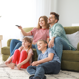 A family watches TV together.