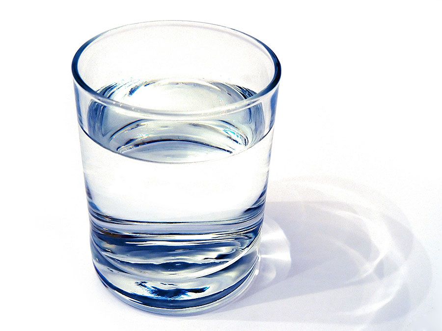 water glass on white background. (drink; clear; clean water; liquid)