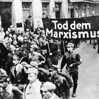 pg 229Nazi parade features a banner proclaiming, "Death to Marxism."The possibility of a peaceful Germany after World War I was precluded entirely by the terms of the Versailles Treaty and theintransigent hostility of France and England. Stripped of indu