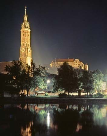 Floodlit spire of St. Martin's Church and Trausnitz Castle, Landshut, Germany.