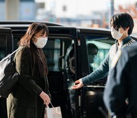 Mako Komuro, left, and her husband Kei Komuro are seen upon their arrival at John F. Kennedy International Airport on Nov. 14, 2021. (Pool photo)=Click/tap photo for more images.