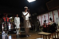 Before a "kagura" performance, Tetsuya Ikeda, second from left, and his sons give a prayer to a lion mask at Kataho Hachiman-jinja shrine in Yurihonjo, Akita Prefecture, on April 17, 2022. He and eldest son Yamato, foreground, will be the lion and second son Taira, left, will be the clown, "Saizo." (Satoshi Takahashi)