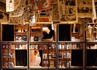 A man is seen relaxing in a bed situated inside a bookshelf at Book and Bed Tokyo in the capital's Shinjuku Ward on Nov. 18, 2021. (Mainichi/Kentaro Ikushima)