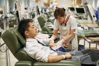 This photo provided by the Japanese Red Cross Society's Kanto-Koshinetsu Block Blood Center shows a man donating blood.