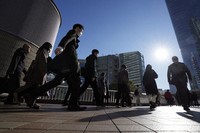 Commuters are seen walking during rush hour at JR Shinagawa Station on Feb. 14, 2024, in Tokyo. (AP Photo/Eugene Hoshiko, File)