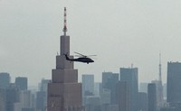 A U.S. Army Black Hawk helicopter is seen flying low near the approximately 270-meter-tall NTT Docomo Yoyogi Building in Tokyo's Shibuya Ward, in this image from video taken on Aug. 18, 2020. The footage, filmed from the Tokyo Metropolitan Government building's 202-meter-high North Observatory in neighboring Shinjuku Ward, shows that the helicopter was flying at an altitude lower than the Docomo building's height. (Mainichi/Takahiro Kato)