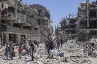 Palestinians walk through the destruction in the wake of an Israeli air and ground offensive in Jebaliya, northern Gaza Strip, on May 30, 2024. (AP Photo/Enas Rami, File)