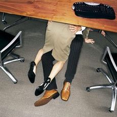 Couple in embrace under a desk