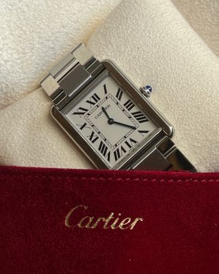 A close up photo of a Cartier Tank Must watch.