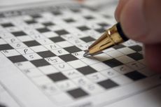 Person solving crossword.