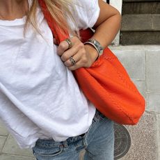 Woman wearing silver bangle bracelet and rings